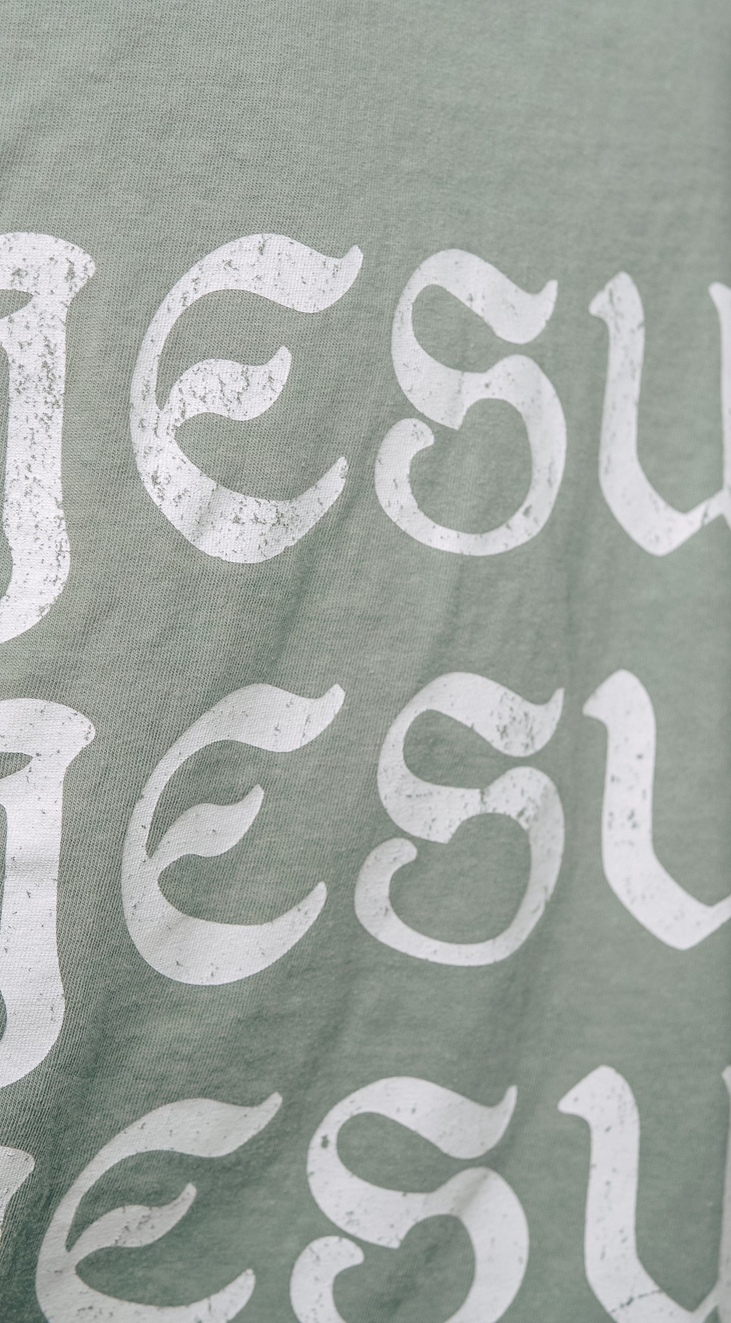 Close-up of Jesus Saves text on Christian graphic tee