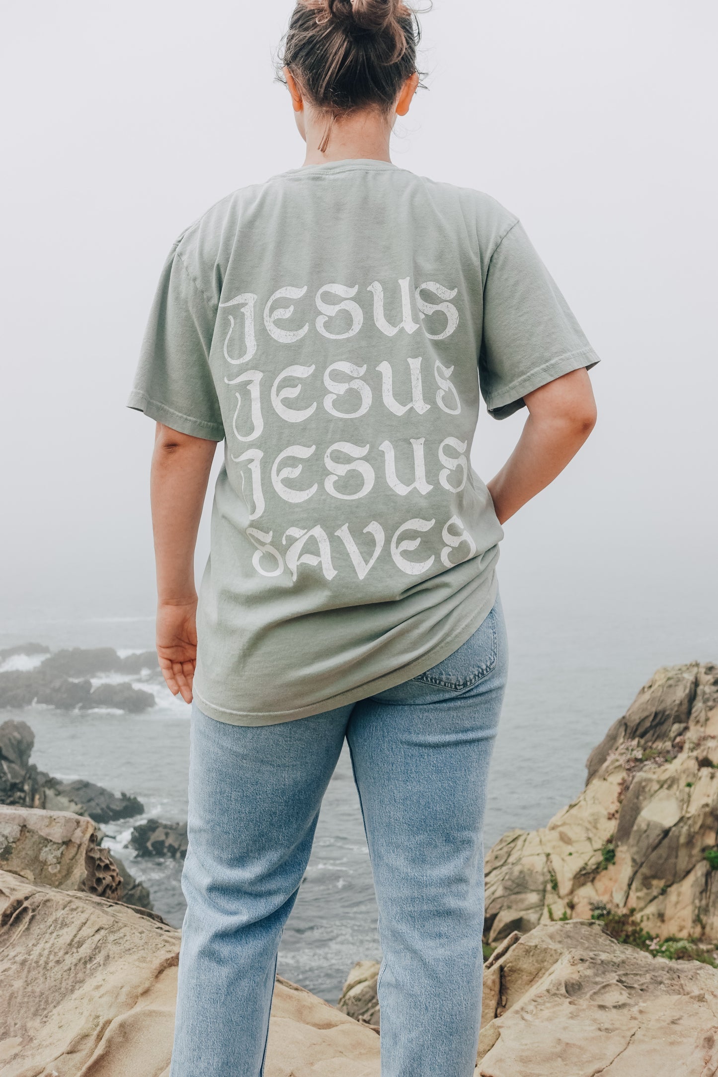 Person wearing Jesus Saves Aesthetic T-Shirt by Saltwear Collective, back view