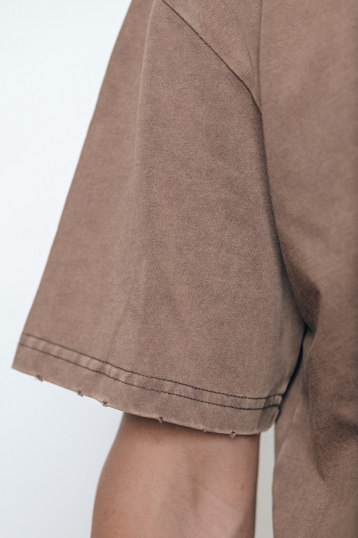 Close-up of the stitching detail on the Let Go & Let God t-shirt collar