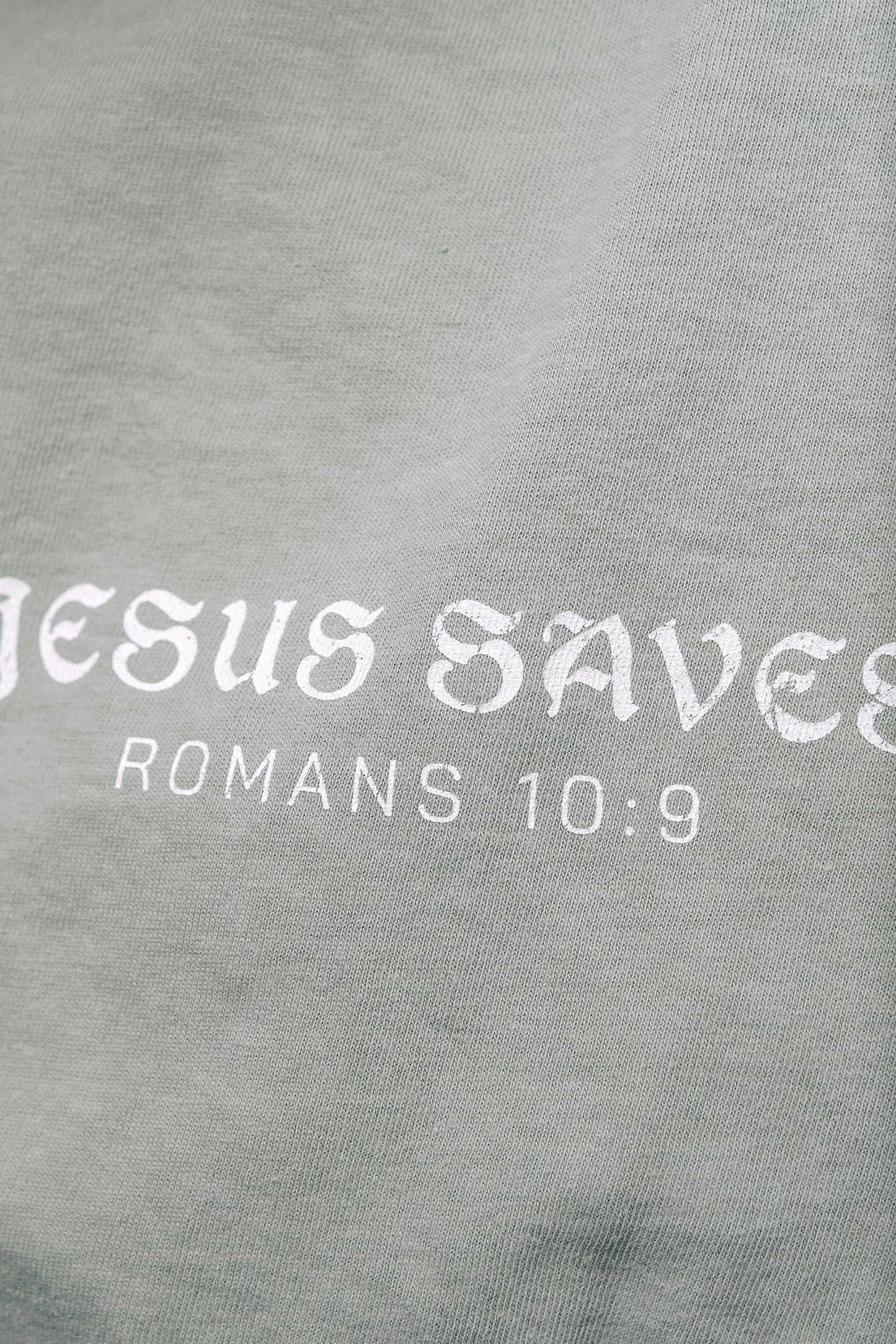 Faith-based aesthetic t-shirt featuring Romans 10:9