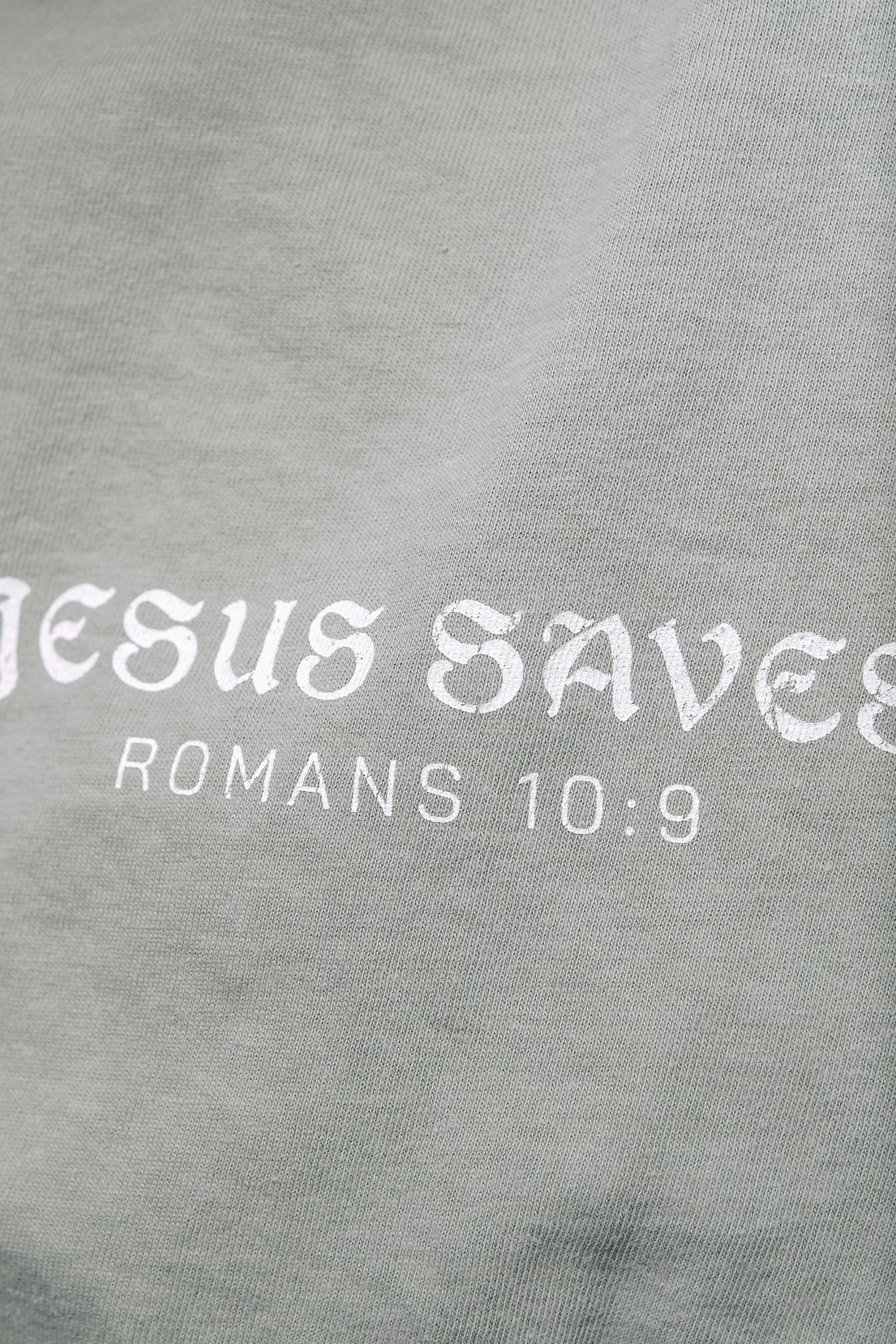 Faith-based aesthetic t-shirt featuring Romans 10:9