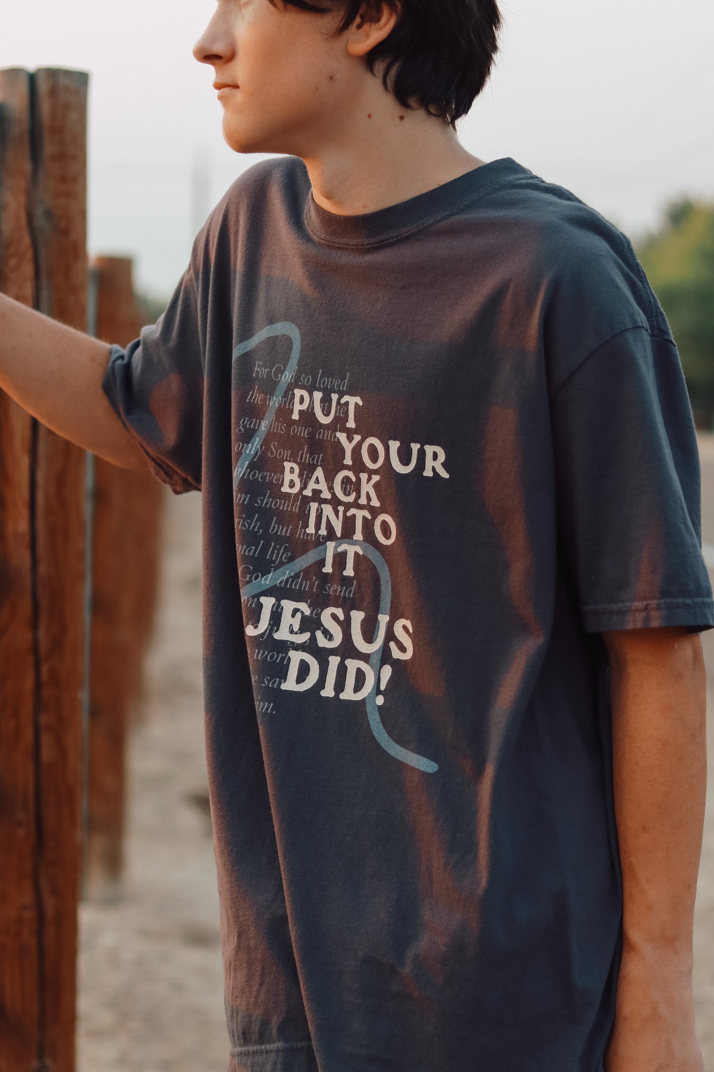 Model wearing Put Your Back Into It T-Shirt in broken-in look