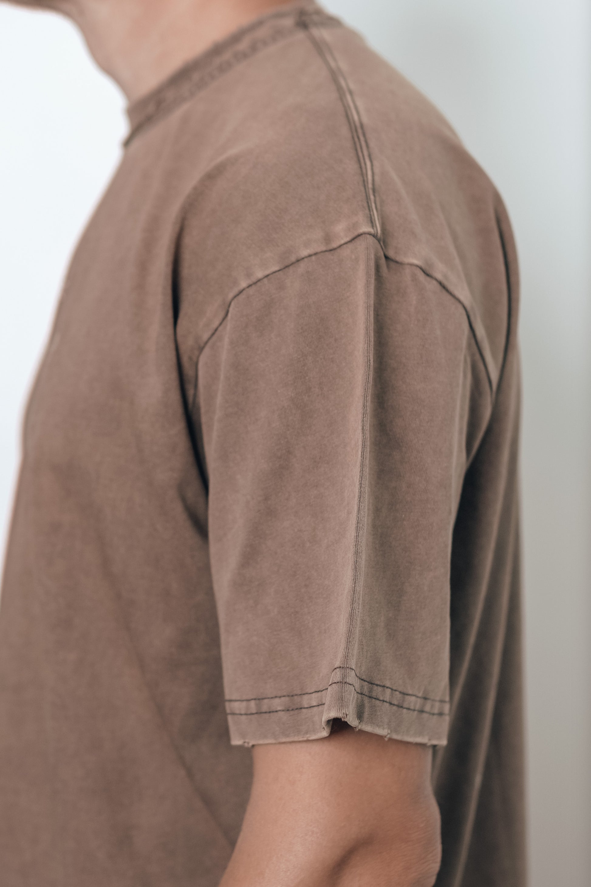 Close-up of the stitching detail on the Let Go & Let God t-shirt collar