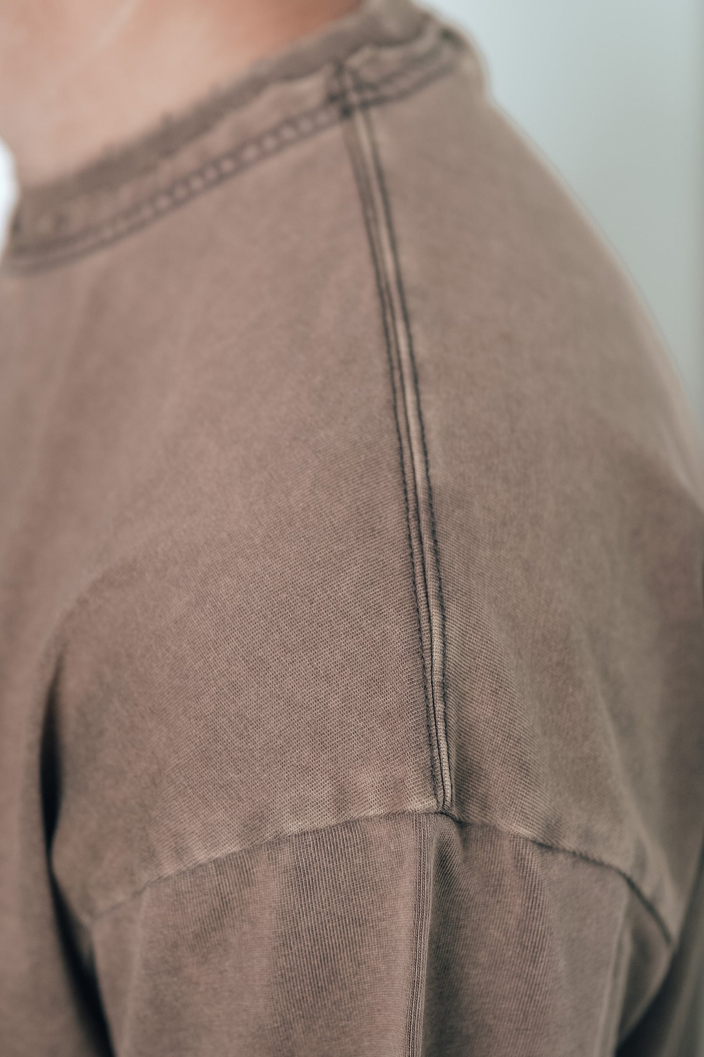 Close-up of the stitching detail on the Let Go & Let God t-shirt collar